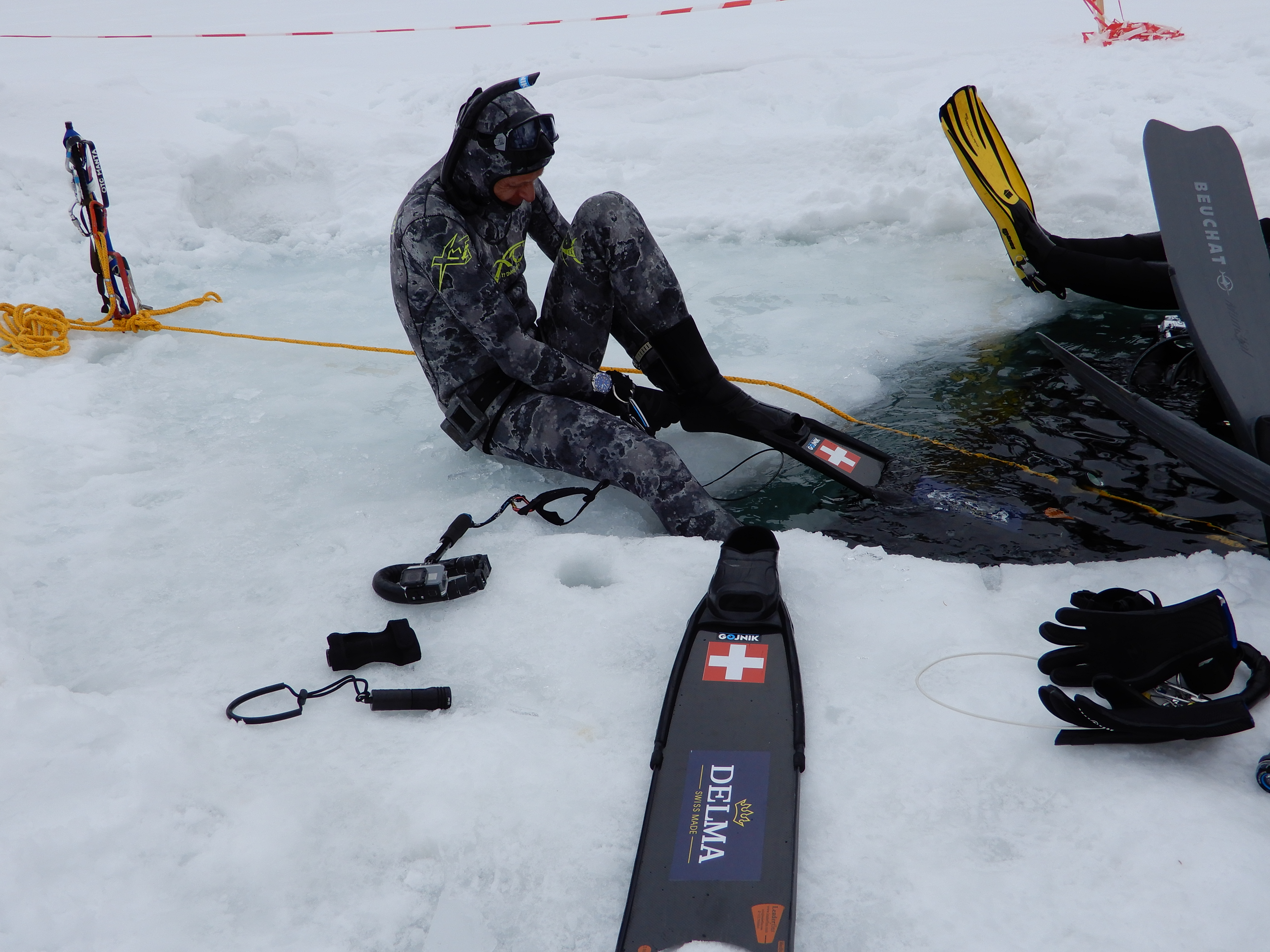 Freediver getting ready to dive under the ice
